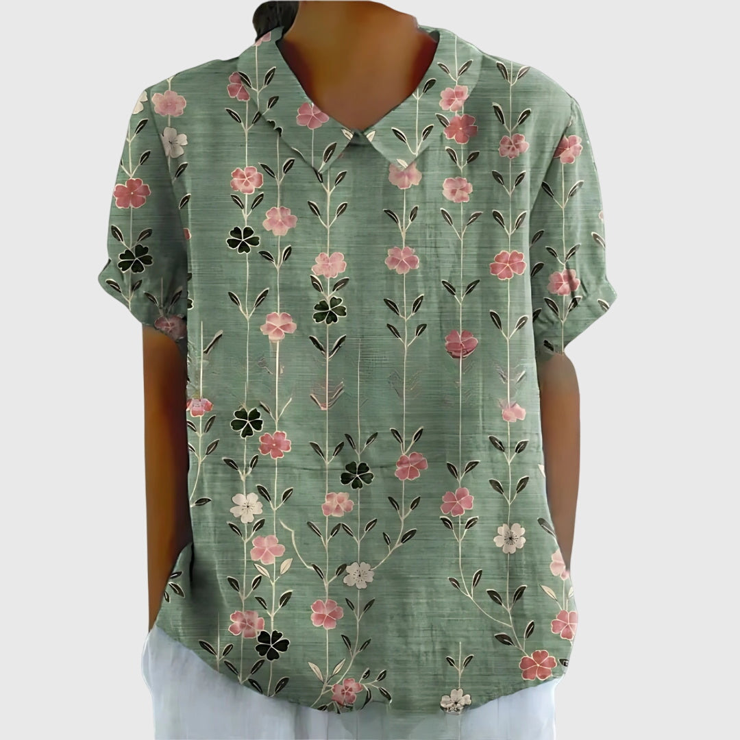 Green floral patterned shirt on a mannequin against a white background
