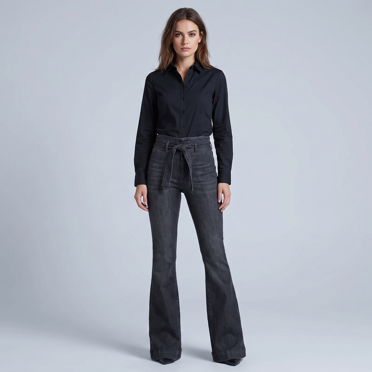 High-waisted, flared black jeans with a belt