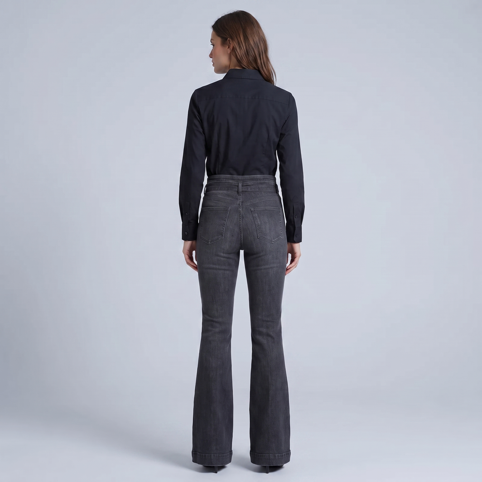 High-waisted, flared black jeans with a belt